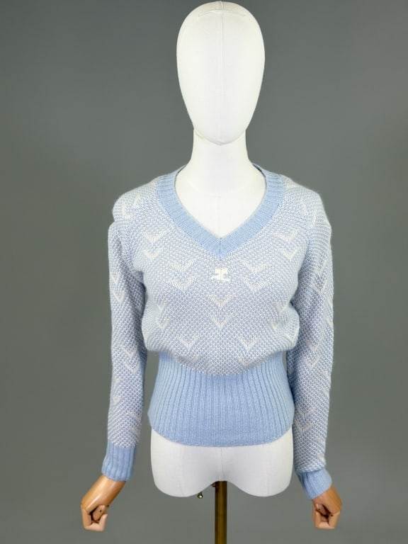 Vintage 1980s Courreges Knit Sweater Top: Vintage 1980s Courreges Knit Sweater Top having v-neck with logo at front. Marked size 0. Measuring 32-40 inch bust, 22-36 inch waist, 22 inches long, 24 inch sleeve length. From the lifetime collecti