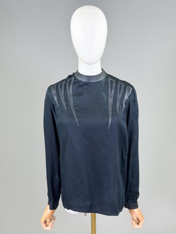 Vintage 1980s Leather Applique Shirt Top: Vintage 1980s Leather Applique Shirt Top having snap closure at shoulder. Can be worn as a set with lot 357. Attributed to Emanuel Zoo. Measuring 40 inch bust, 25 inches long, 22 inch sleeve length, F