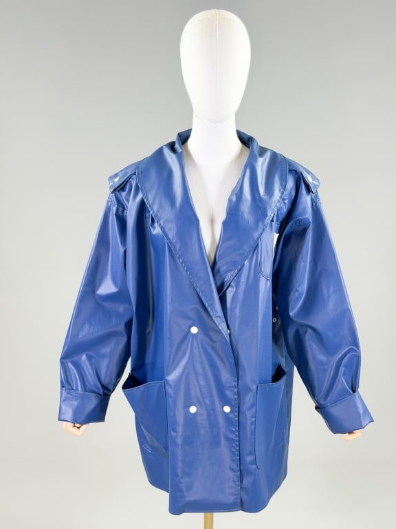 Vintage 1980s Wippette Vinyl Raincoat Jacket: Vintage 1980s Wippette Vinyl Raincoat Jacket having snap front closure with three front pockets. Marked size Medium. Measuring 56 inch bust, 33 inches long, 21 inch sleeve length. General wear as show