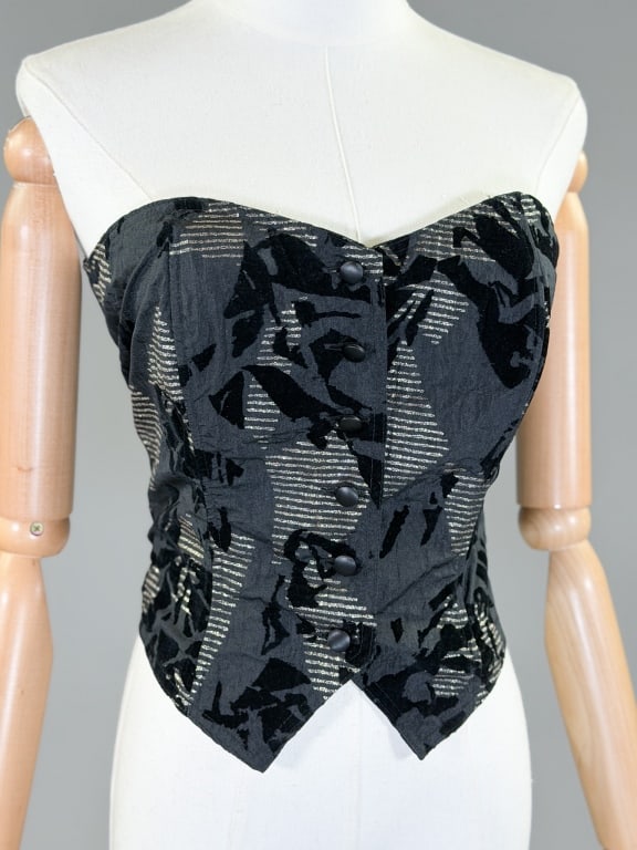 Vintage 1980s Velour Printed Metallic Bustier Top: Vintage 1980s Velour Printed Metallic Bustier Top having button front closure with elastic back. Marked size US 12. Measuring 34-40 inch bust, 30-36 inch waist, 14 inches long. From the lifetime colle