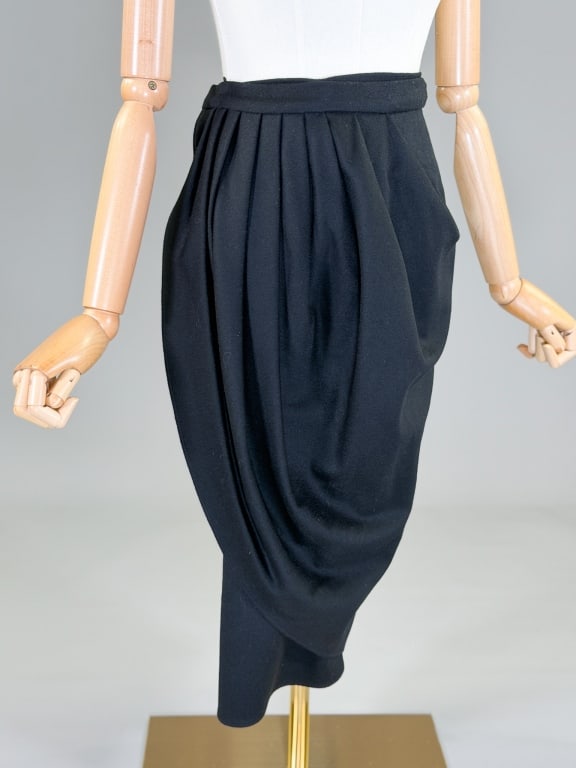 Vintage 1980s Draped Wool Wrap Skirt: Vintage 1980s Draped Wool Wrap Skirt having wrap closure at waist. Measuring 26 inch waist, 28 inches long. From the lifetime collection, fashion archive and business inventory of collector and dealer