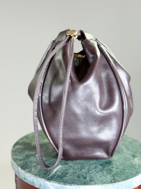 Vintage 1990s De Vecchi Leather Pouch Bag: Vintage 1990s De Vecchi Leather Pouch Bag having drawstring top. Measuring approximately 10 inches high by 5 inches wide by 4 inches deep. General wear as shown throughout. From the lifetime collectio