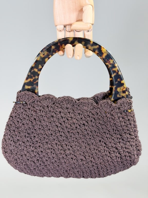 Vintage 1990s Ribbon Crochet Top Handle Purse Bag: Vintage 1990s Ribbon Crochet Top Handle Purse Bag having magnetic snap closure and faux tortoise plastic top handles. Measuring approximately 7 inches high by 11 inches wide by 3 inches deep. From the