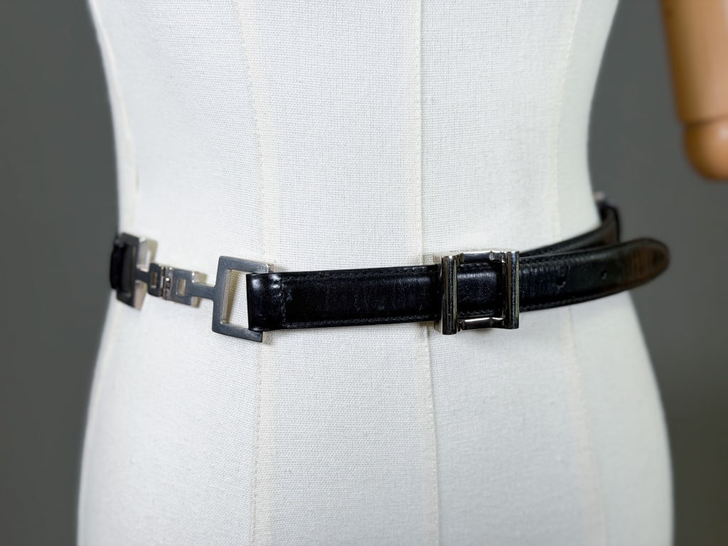 Vintage 1990s Gucci Leather Belt: Vintage 1990s Gucci Leather Belt having metal buckle and metal details at sides. Marked size 30. Measuring approximately 33 inches total length. From the lifetime collection, fashion archive and busin