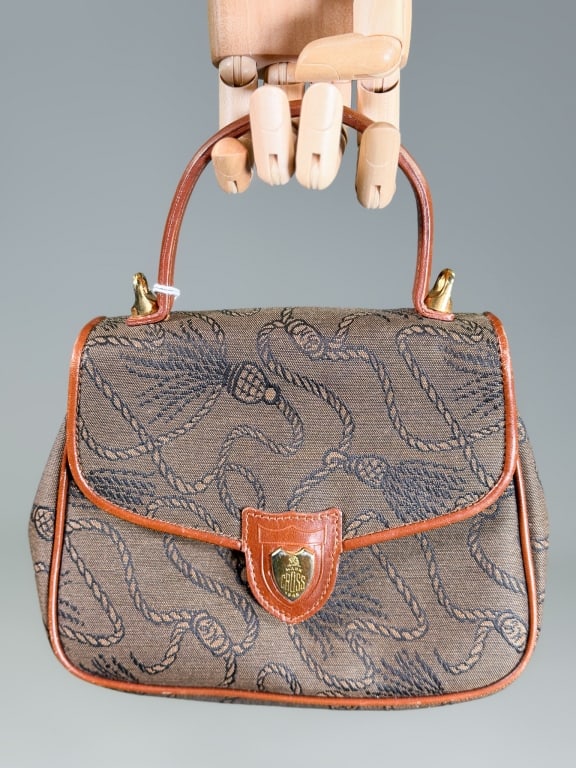 Vintage Mark Cross Printed Canvas Leather Bag: Vintage Mark Cross Printed Canvas Leather Top Handle Bag Purse having top handle with magnetic snap closure and interior pocket. Measuring approximately 6 inches high by 8 inches wide by 3 inches deep