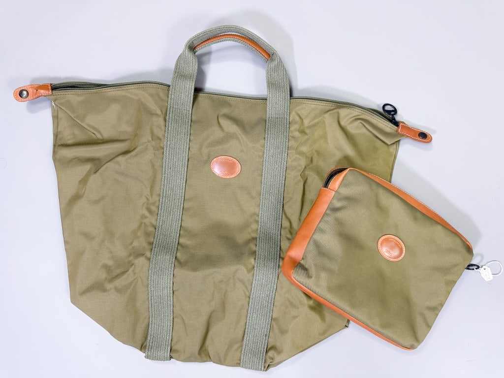 Vintage Longchamp Nylon Travel Duffle Bag: Vintage Longchamp Nylon Travel Duffle Bag having zip top closure and carrying case. Measuring approximately 18 inches high by 24 inches wide. From the lifetime collection, fashion archive and business