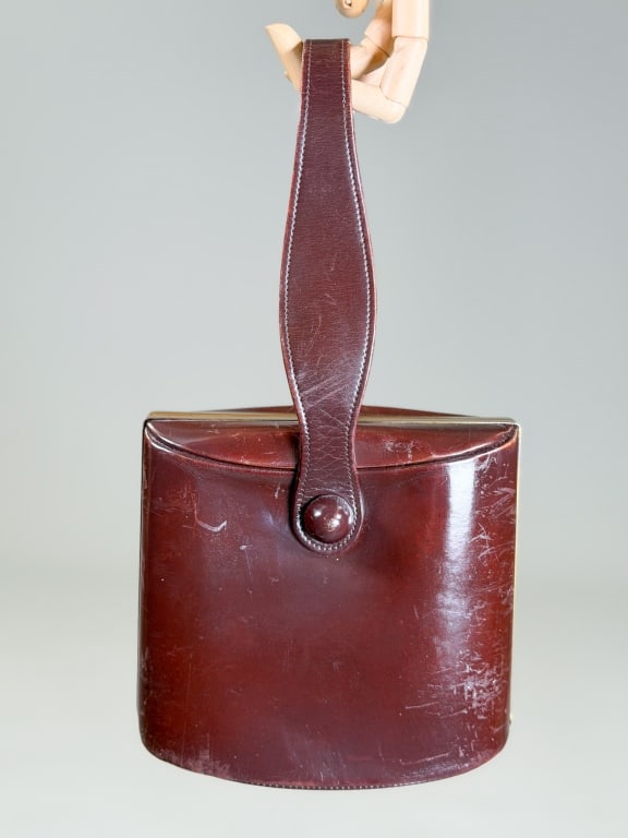 Vintage Mark Cross Leather Clutch Bag: Vintage Mark Cross Leather Clutch Bag having metal frame lock closure and top handle. Measuring approximately 7 inches high by 7.5 inches wide by 3 inches deep. From the lifetime collection, fashion a