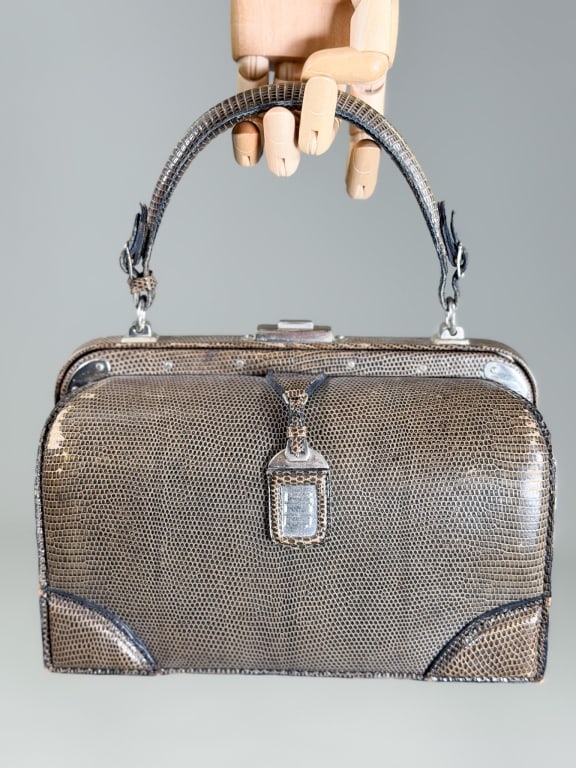 Vintage Lederer Lizard Skin Box Bag: Vintage Lederer Lizard Skin Box Bag having metal frame lock closure with top handle. Measuring approximately 7 inches high by 9 inches wide by 3.5 inches deep. General wear as shown throughout. From t