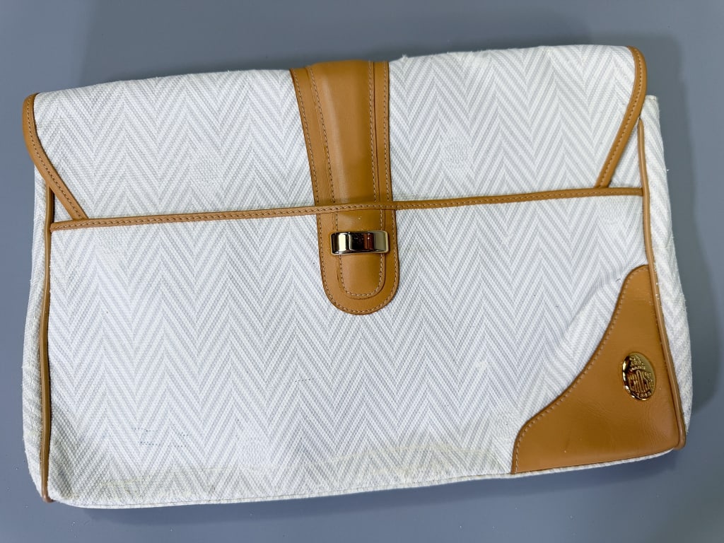 Vintage Mark Cross Canvas Clutch Bag: Vintage Mark Cross Canvas Clutch Bag having magnetic snap closure with interior pockets. Measuring approximately 9 inches high by 13 inches wide by 2 inches deep. General wear as shown throughout. Fro