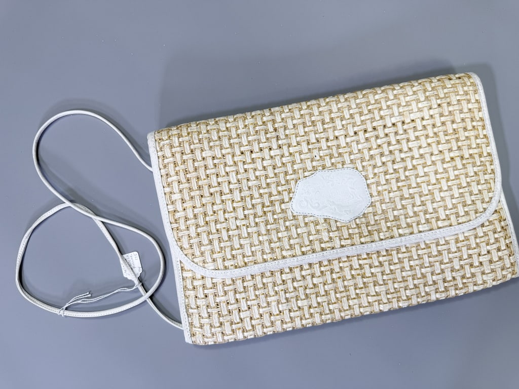 Vintage Carlos Falchi Raffia Woven Clutch Bag: Vintage Carlos Falchi Raffia Woven Clutch Bag having magnetic snap closure with crossbody strap. Measuring approximately 8.5 inches high by 13 inches wide. From the lifetime collection, fashion archiv