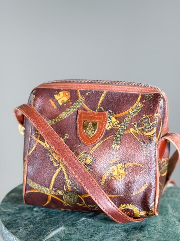 Vintage Mark Cross Canvas Printed Cross Body Bag: Vintage Mark Cross Canvas Printed Cross Body Bag having zip top closure with crossbody strap. Measuring approximately 7 inches high by 7 inches wide by 3 inches deep. From the lifetime collection, fas