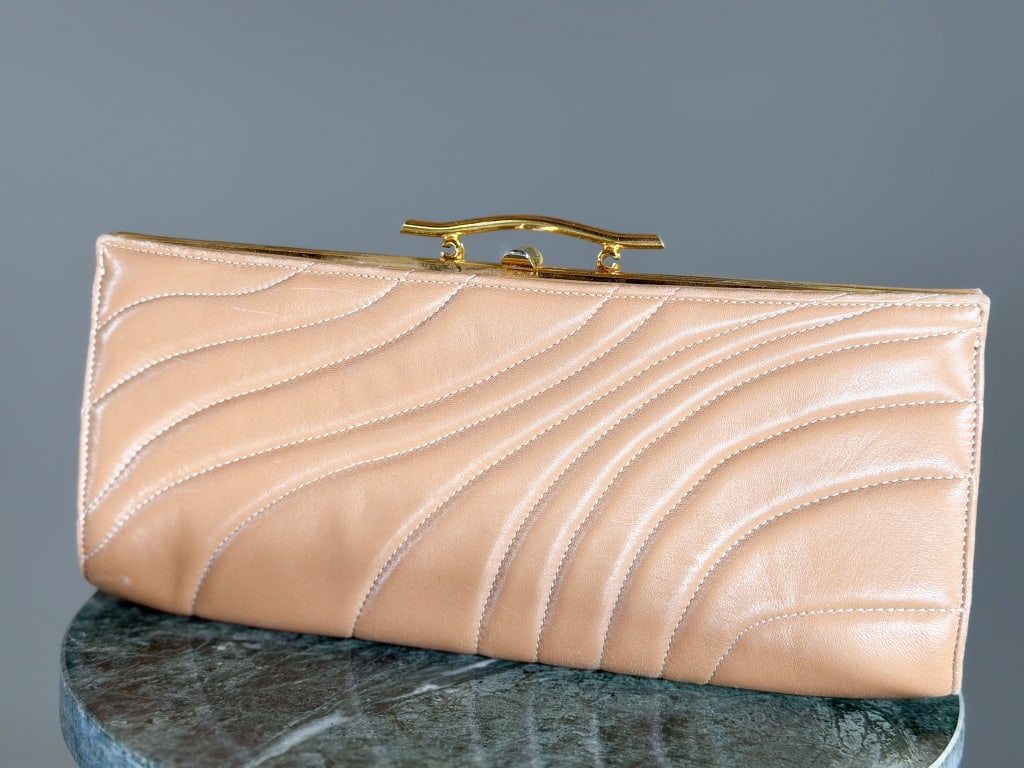 Vintage Rodo Quilted Leather Clutch Purse: Vintage Rodo Quilted Leather Clutch Purse having metal frame lock closure with quilting throughout. Measuring approximately 5 inches high by 10.5 inches wide by 1 inch deep. From the lifetime collecti