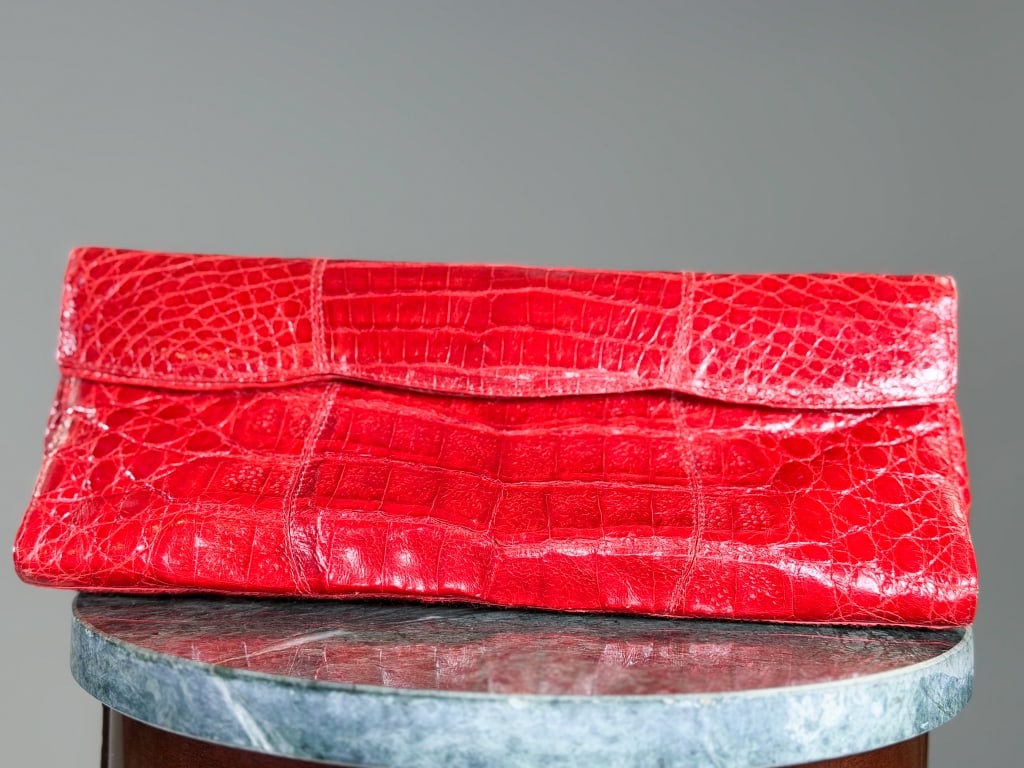 Vintage Nancy Gonzalez Crocodile Clutch Purse: Vintage Nancy Gonzalez Crocodile Clutch Purse having magnetic snap closure and interior pockets. Measuring approximately 5 inches tall by 11 inches wide by 2.5 inches deep. From the lifetime collectio