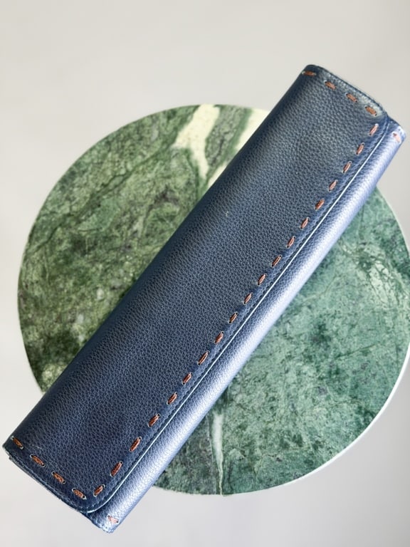 Vintage Carlos Falchi Leather Clutch Bag: Vintage Carlos Falchi Leather Clutch Bag having magnetic snap closure and stitch details. Measuring approximately 4 inches high by 13 inches wide by 2 inches deep. From the lifetime collection, fashio