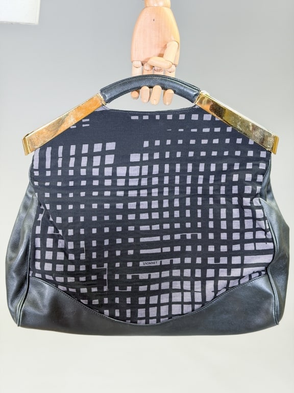 Vintage Vionnet Paris Printed Fabric Leather Bag: Vintage Vionnet Paris Printed Fabric Leather Bag having metal handle closure with leather clutch strap. Measuring approximately 18 inches high by 17 inches wide by 5 inches deep. From the lifetime col