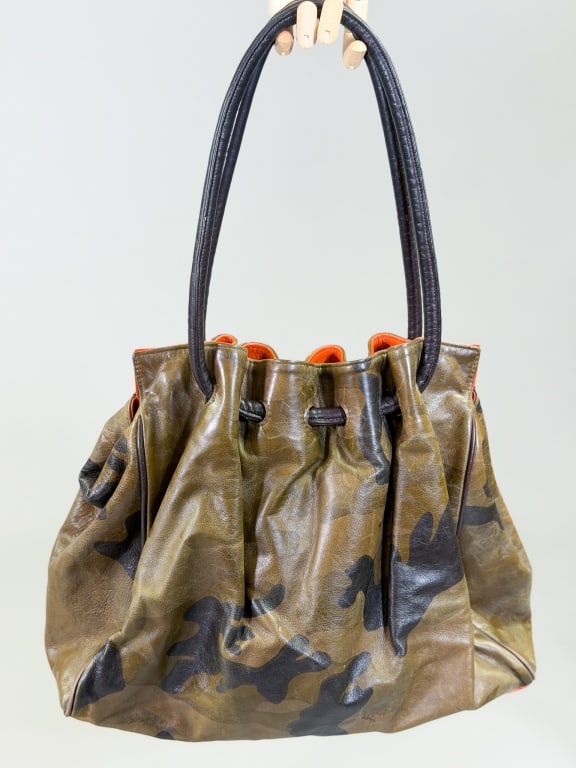 Vintage Camouflage Leather Purse Bag: Vintage Camouflage Leather Purse Bag having drawstring shoulder strap closure with magnetic snaps. Measuring approximately 13 inches high by 16 inches wide by 5 inches deep. From the lifetime collecti