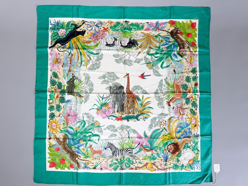 Vintage Gucci Silk Jungle Animal Print Scarf: Vintage Gucci Silk Jungle Animal Print Scarf having print throughout with hand rolled edges. Measuring approximately 34 inches by 34 inches. General wear as shown throughout. From the lifetime collect