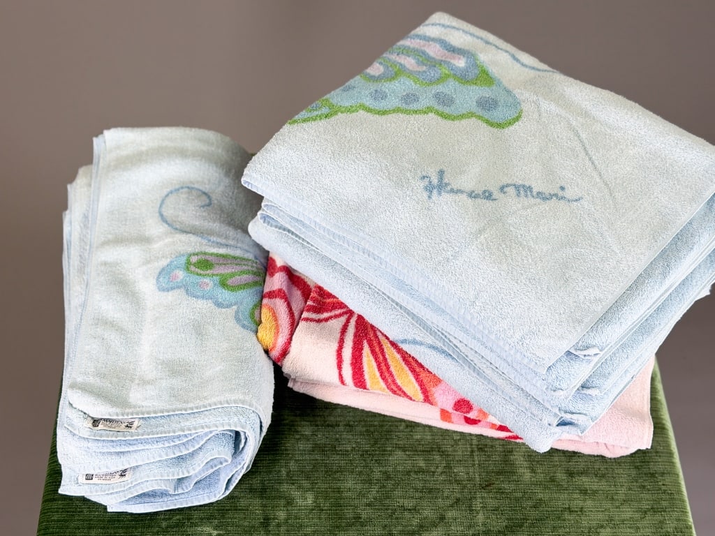 Group of Vintage Hanae Mori Cotton Towels: Group of Vintage Hanae Mori Cotton Towels including eleven total with butterfly print throughout all. Larger towels measuring approximately 48 inches by 28 inches. General wear as shown throughout. Fr