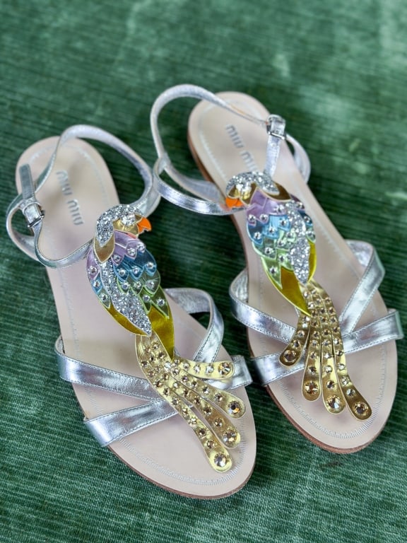 Vintage Miu Miu Rhinestone Leather Parrot Sandals: Vintage Miu Miu Rhinestone Leather Parrot Sandals having ankle buckle strap closure with rhinestone parrot detail at front. Marked size 37.5. Measuring approximately 9.75 inches heel to toe. General w