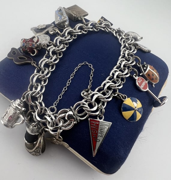 1960s Sterling Bracelet Charm Collection 70 Gram: Vintage Circa 1960s Sterling Bracelet Charm Collection 70 Gram. Vintage sterling silver multi ring bracelet with collection of 18 charms. Bracelet and multiple pieces with hallmarks or STERLING stamps