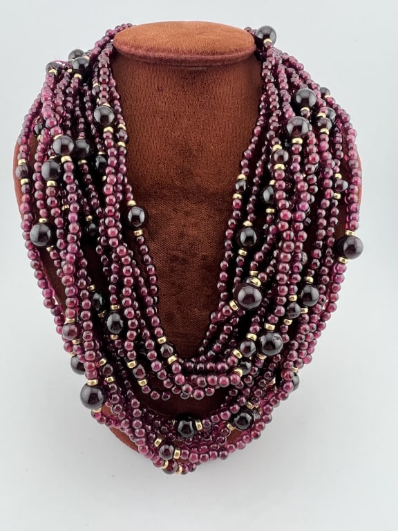 Estate 14kt Yellow Gold & Garnet Beaded Necklace: Estate 14kt Yellow Gold & Garnet Beaded Necklace. Yellow gold clasp. Designed with six strands of garnet beads with gold accent beads. Measures approximately 33 inches in length. From the lifetime col