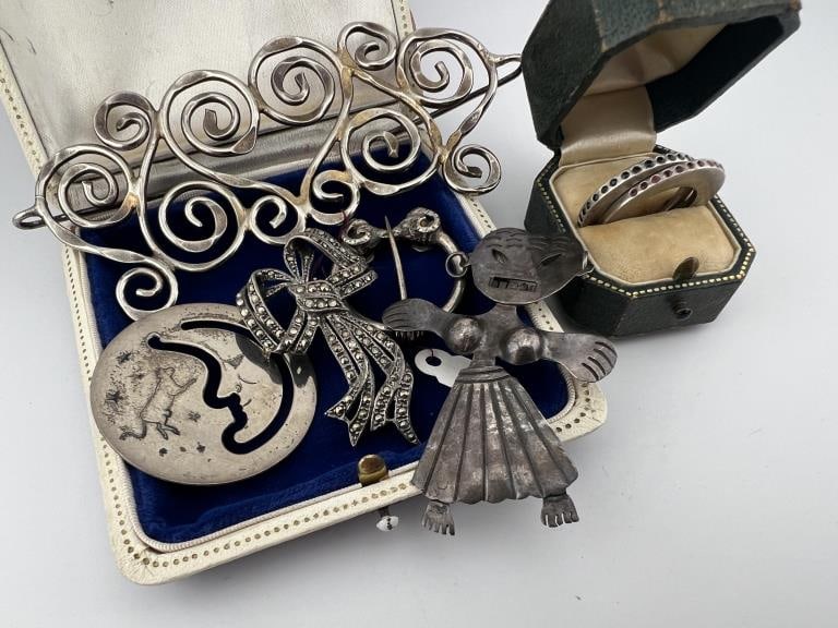Collection Sterling Silver Vintage Jewelry Items: Collection Sterling Silver Vintage Jewelry Items. Large scrollwork brooch, ram's head design fibula, crescent moon pendant, bow brooch, pair of rings, figural brooch. Total weight approximately 65 gra