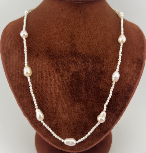 Estate 14kt Yellow Gold & Baroque Pearl Necklace: Estate 14kt Yellow Gold & Baroque Pearl Necklace. Necklace strand with seed pearls and baroque pearls set with a 14kt yellow gold clasp. Clasp is hallmarked 585. Measures 15 inches in length.