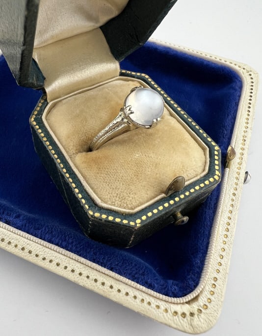Antique Art Deco 14kt Gold Moonstone Cabochon Ring: Antique Art Deco 14kt Gold Moonstone Cabochon Ring. Prong set round cabochon moonstone in 14kt white gold setting, hallmarked. Moonstone with bluish flash of adularescence. Ring size 5.75