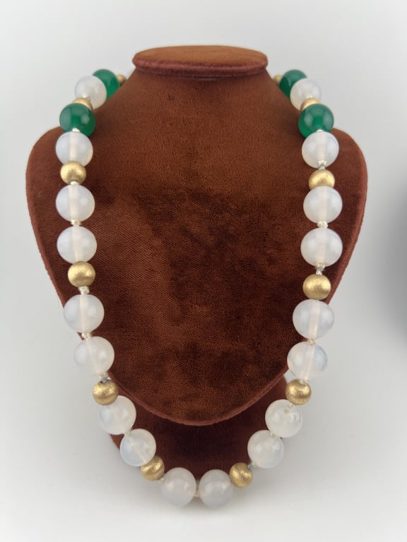 Estate 14kt Gold Hand Knotted Jade Necklace: Estate 14kt Gold Hand Knotted Jade Necklace. Hand knotted silk thread necklace with Florentine finish 14kt yellow gold beads and a 14kt gold filigree clasp. Necklace set with approximately 10 mm round