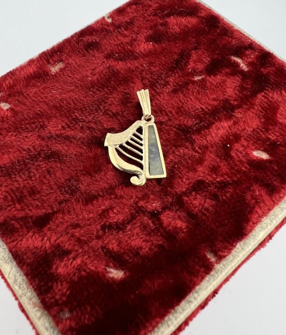 English 9kt Gold Harp Pendant w Connemara Marble: English 9kt Gold Harp Pendant w Connemara Marble. Hallmarked on the back. Measures .75 of an inch in length.