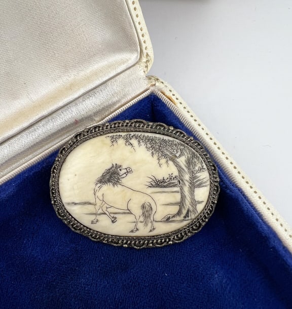 Antique Chinese Export Engraved Horse Scene Brooch: Antique Chinese Export Engraved Horse Scene Brooch. Back is stamped CHINA and the setting is in silver filigree. Incised and inked manner of scrimshaw oval cow or ox bone plaque at center. Measures ju