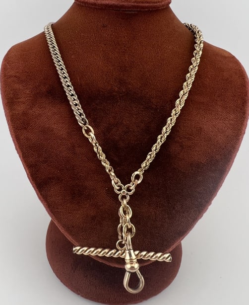 Antique Gold Filled Watch Chain Necklace w T Bar: Antique Gold Filled Watch Chain Necklace w T Bar & Dog Clip. Curb link, rope chain, floral design fastener connecting the chains to a drop with dog clip and T bar. Gold filled element. Spring ring cla