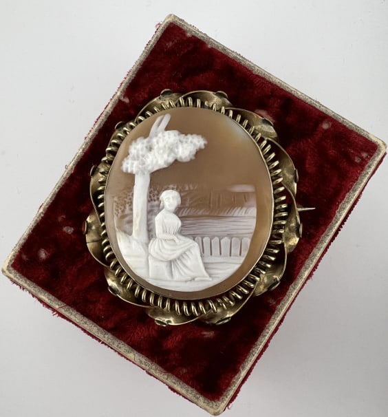 Antique 19th C Victorian Gold Brooch w Cameo: Antique 19th C Victorian Gold Brooch w Cameo. Hand carved shell cameo of a woman in a garden. Set in an ornate frame, likely gold filled, however elements of the frame do machine test at approximately