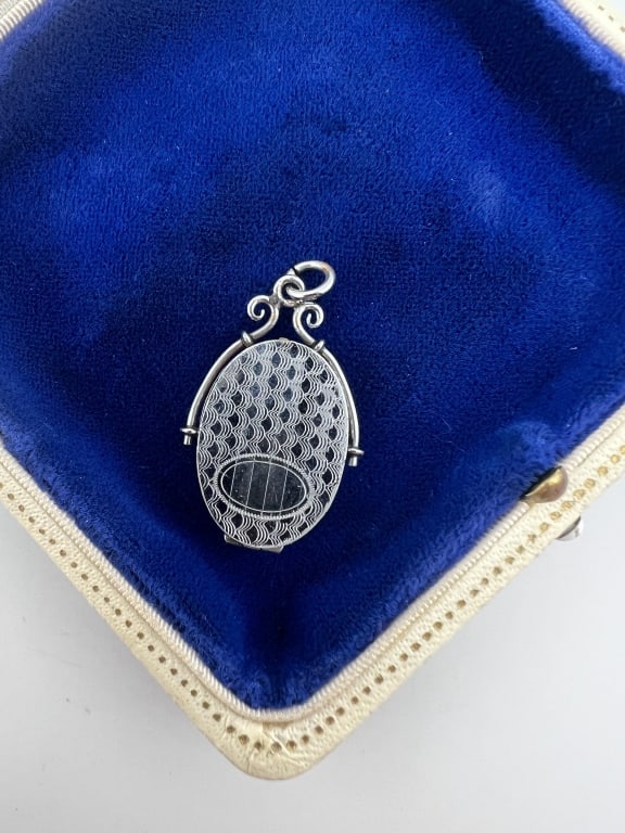 Antique White Gold Filled Locket Necklace Pendant: Antique White Gold Filled Locket Necklace Pendant. Having an Art Deco engraved design. Measures 1.5 inches in length.