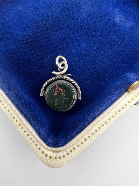 Antique Sterling Silver & Bloodstone Spinner Fob: Antique Sterling Silver & Bloodstone Spinner Fob. One side with bloodstone, one side with carnelian, English hallmarks. Measures 1 inch in length.