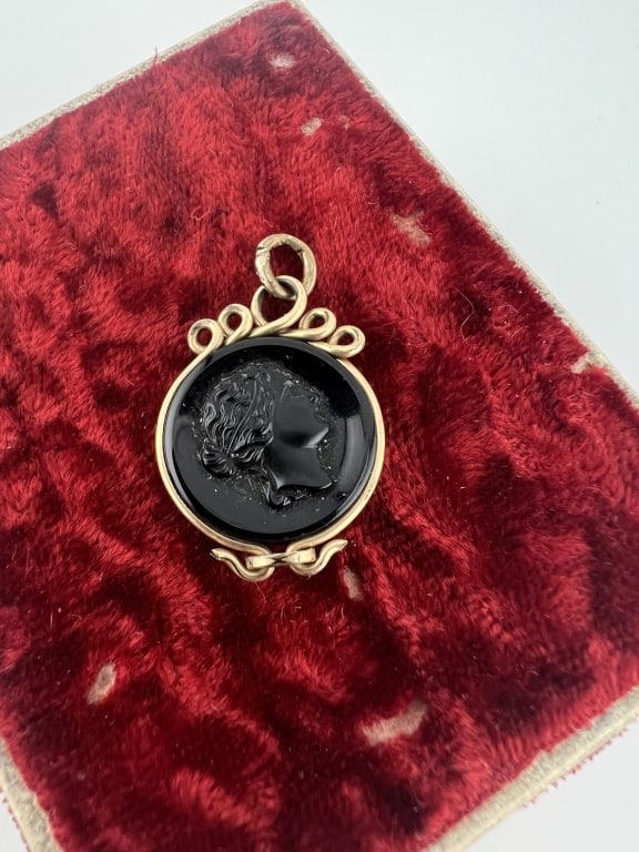 Antique 19th C Carved Carnelian Cameo Pendant: Antique 19th C Carved Carnelian Cameo Pendant. Greco Roman style portrait cameo in silhouette form. Measures 1.25 inches in length.