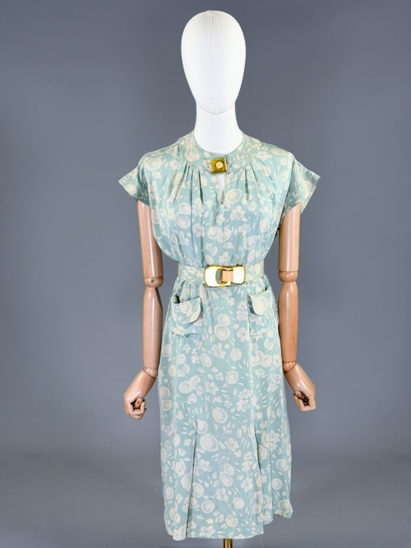 Vintage 1930s Floral Silk Deco Day Dress: Vintage 1930s Floral Silk Deco Day Dress having neck and side snap closures with two front pockets and belt at waist. Measuring 38 inch bust, 32 inch waist, 39 inches long, 5 inch sleeve length.