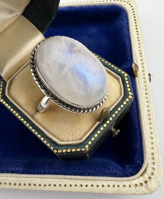 Sterling Silver Ring w Large Moonstone Cabochon: Sterling Silver Ring w Large Moonstone Cabochon. Hallmarked. Ring size 10.5 and the moonstone cabochon in bezel measures over 1 inch in length. The moonstone shows a nice blue flash / adularescence.