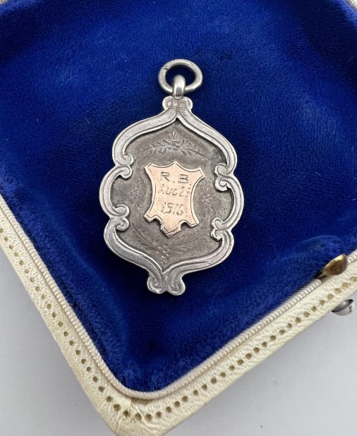 Large Antique English Sterling Shield Pendant Fob: Large Antique English Sterling Silver Shield Pendant Fob. Necklace pendant or watch chain fob. Having gold wash at center. Dated 1916 and inscribed on the back reading "SGT B Cartwright Cross Country 