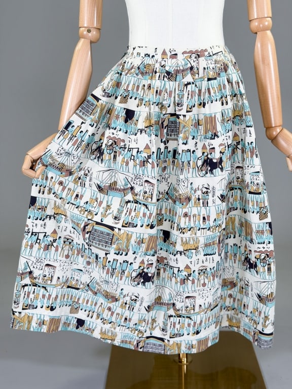 Vintage 1950s Cotton Egyptian Novelty Print Skirt: Vintage 1950s Cotton Egyptian Novelty Print Skirt having side zip closure. Measuring 26 inch waist, 28 inches long.