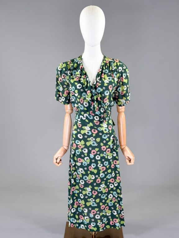 Vintage 1940s Rayon Floral Tassel Dress: Vintage 1940s Rayon Floral Tassel Dress having snap and zip closures with fringe detail at front. Measuring 38 inch bust, 28 inch waist, 45 inches long, 9 inch sleeve length. General wear and tearing 