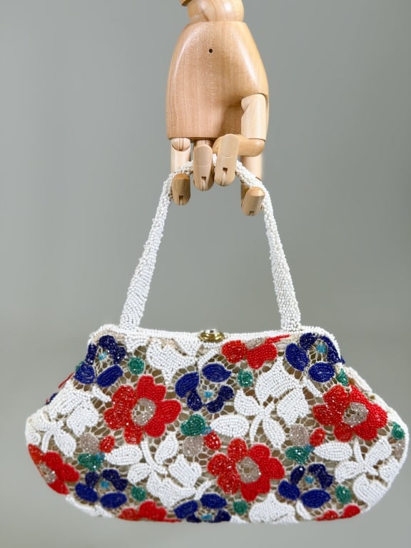 Vintage 1950s Floral Beaded Hand Bag Purse: Vintage 1950s Floral Beaded Purse Bag having beading throughout with metal frame lock closure. Measuring approximately 7 inches high by 12 inches wide by 2 inches deep.