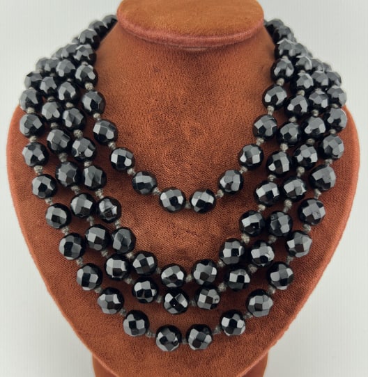 Antique Art Deco Flapper Austrian Crystal Necklace: Antique Art Deco Flapper Austrian Crystal Necklace. Clasp is marked MADE IN AUSTRIA. Hand knotted French Jet type faceted black crystals. Measures 58 inches in length.