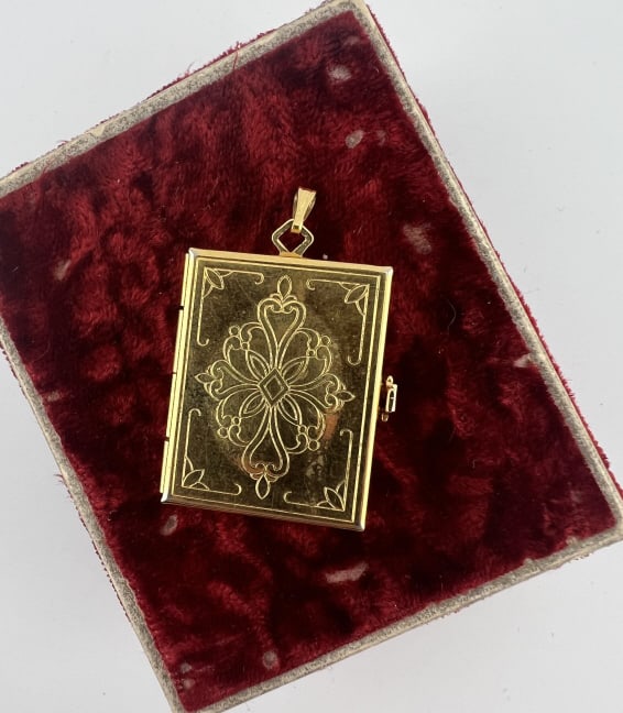 Large Scale Book Form Locket Necklace Pendant: Large Scale Book Form Locket Necklace Pendant. Interior opens to a section that folds out. Measures just over 1.5 inches in length. Unmarked, gilt metal or gold plated / gold filled.