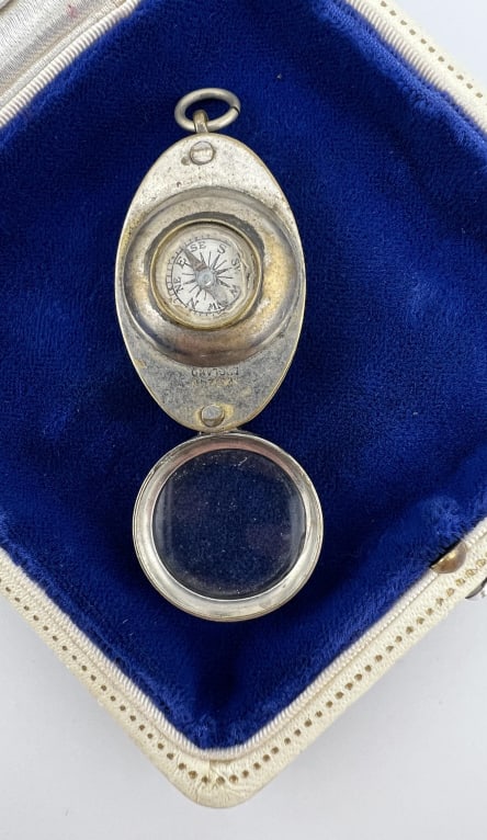 Antique English Compass Design Necklace Pendant: Antique English Compass Design Necklace Pendant. Made to resemble a ship's pulley. Marked MADE IN ENGLAND. Measures 2 inches in length.