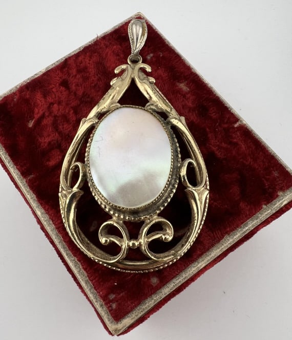 Caravelle Watch Whiting & Davis Necklace Pendant: Caravelle Watch Whiting & Davis Necklace Pendant. Vintage necklace pendant with mother of pearl plaque on the front set with a watch on the back. Watch is marked Caravelle on the face, pendant is mark