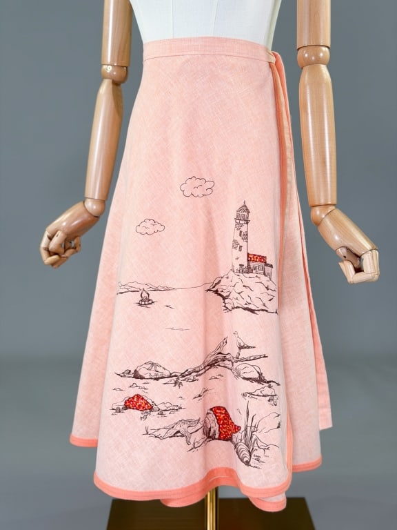 Vintage 1970s Beach Print Patchwork Wrap Skirt: Vintage 1970s Beach Print Patchwork Wrap Skirt having wrap tie closure at waist and beach scene with patchwork pieces at front. Measuring adjustable waist, 28 inches long.