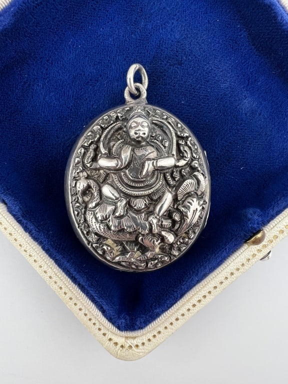 Antique 19th C Anglo Indian Silver Ornate Locket: Antique 19th C Anglo Indian Silver Ornate Repousse Locket. This antique late 19th century repousse silver tests at approximately sterling grade and shows a scene of Kamadeva the god of love and desire