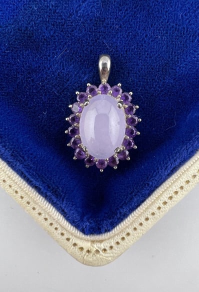 Sterling Silver Lavender Jade & Amethyst Pendant: Sterling Silver Lavender Jade & Amethyst Pendant. Necklace pendant, cabochon lavender jade at center, halo of amethyst. Hallmarked. Measures just over 1 inch in length. Stones test on the Presidium, m