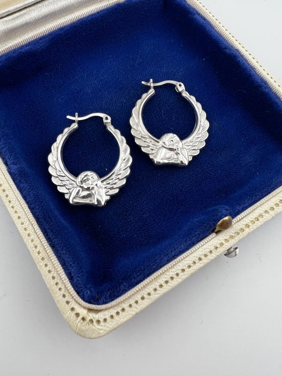 Sterling Silver Raffaello Motif Angel Hoop Earring: Pair of Sterling Silver Raffaello Motif Angel Hoop Earrings. Hallmarked. Each measures 1.25 inches in length.